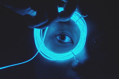 Close-up portrait of woman looking through wire