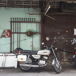 Bicycle parked against wall in old building