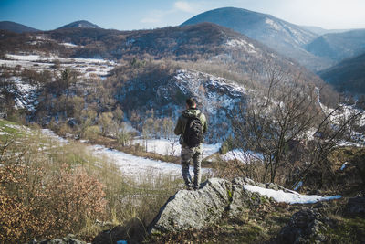 Man walking on mountain during winter
