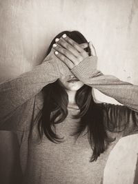 Portrait of woman covering face