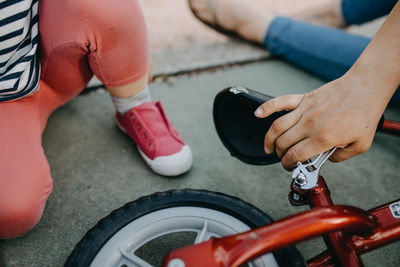 Mother and child fixing bike