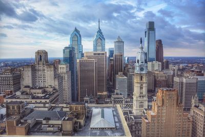 City skyline against cloudy sky