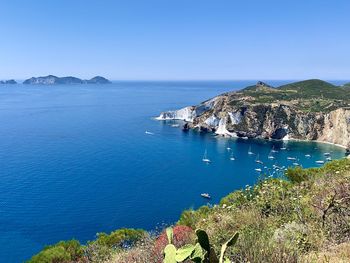 High angle view of sea against clear blue sky