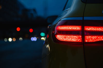 Close-up of illuminated red car in city at night