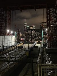 Illuminated modern buildings against sky at night