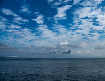 Scenic view of sea and buildings against sky
