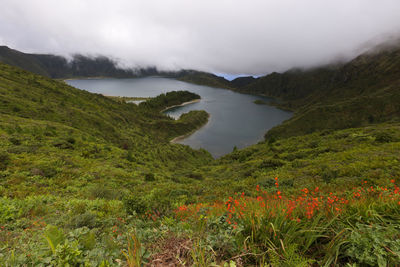 Scenic view of river and mountains against sky