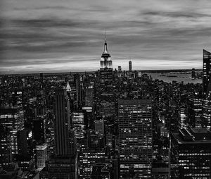 Buildings in city against cloudy sky