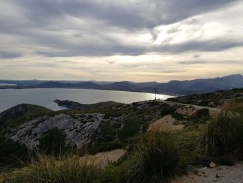 Scenic view of sea and mountains against sky