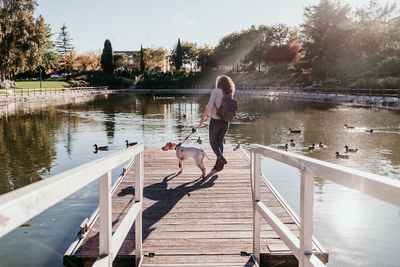 People on lake against trees