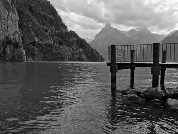 Scenic view of lake in front of mountains against sky