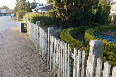 Footpath by fence at cemetery