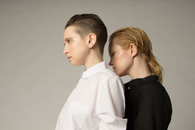 Portrait of boy looking away against white background