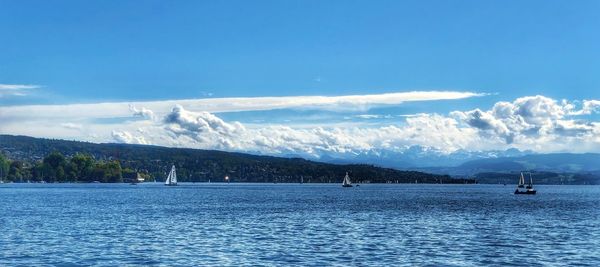 Scenic view of sea against blue sky