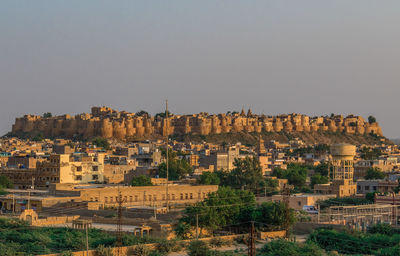 Buildings in city against clear sky