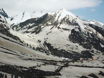 Scenic view of snow covered mountains against sky