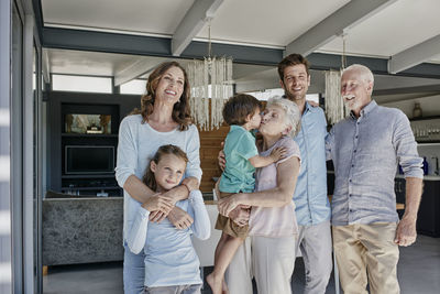 Multi generation family standing in family home