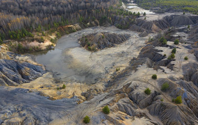 Aerial view of abandoned quarry with canyons and cracks.