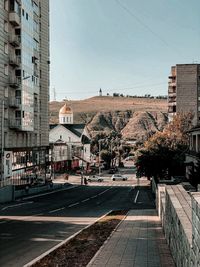 Street amidst buildings against clear sky