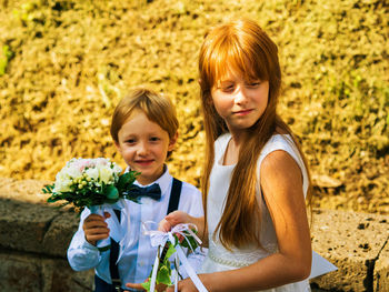 Portrait of happy girl holding flower bouquet