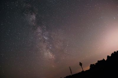 Low angle view of silhouette stars against sky at night