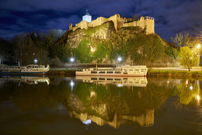Reflection of trees in lake against sky at night