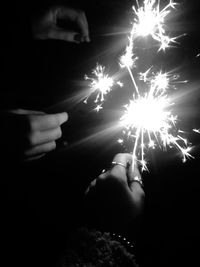 Low angle view of illuminated fireworks at night