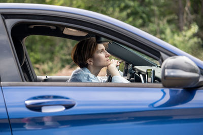 Side view of woman in car