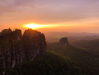 Scenic view of rock formation against sky during sunset