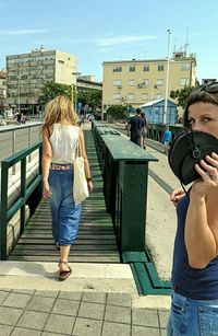 Woman standing on city street