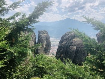 Scenic view of rocks and trees against sky