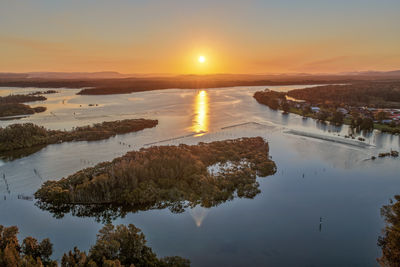 Scenic view of lake against sky during sunset