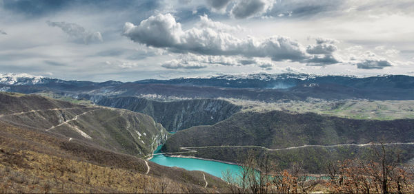 Aerial view of landscape against cloudy sky