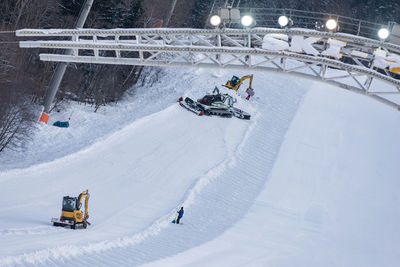 People skiing on snow covered land