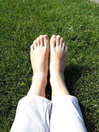 Low section of woman relaxing on field