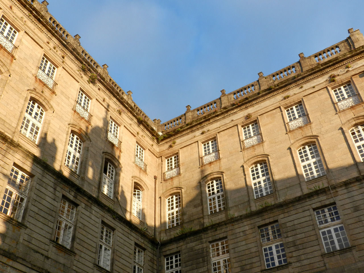 building exterior, built structure, architecture, sky, low angle view, window, no people, building, nature, history, city, the past, travel destinations, day, outdoors, blue, clear sky, residential district, sunlight, apartment, ornate