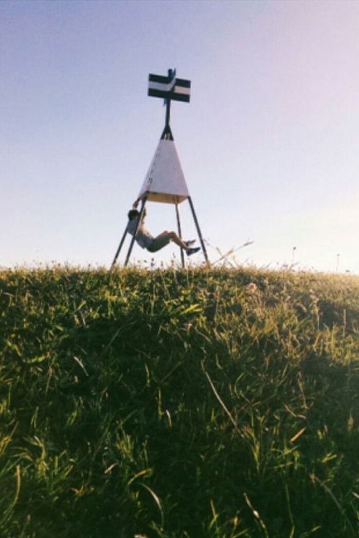 CLOSE-UP OF WINDMILL IN FIELD