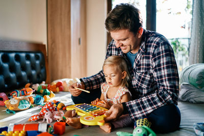 Mother playing with toys at home