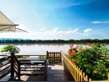 Built structure by lake against sky