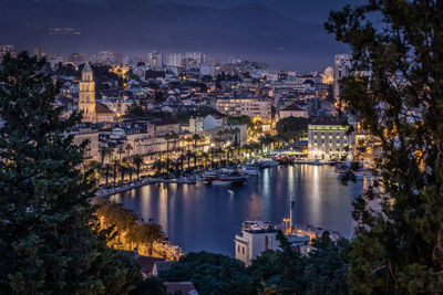 High angle view of illuminated buildings in city of split. old town and marina view at blue hour
