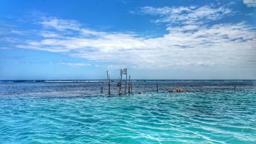 Scenic view of sea against cloudy sky