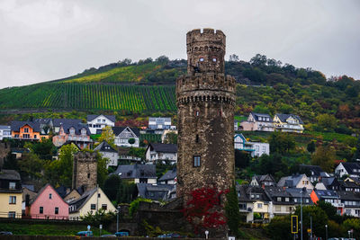 Low angle view of historic tower at oberwesel against mountain