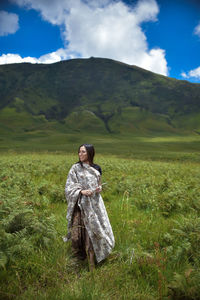 Full length of woman on field against sky