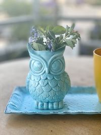 Ceramic owl flowerpot on table 