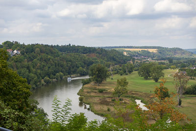 High angle view of river amidst trees against sky