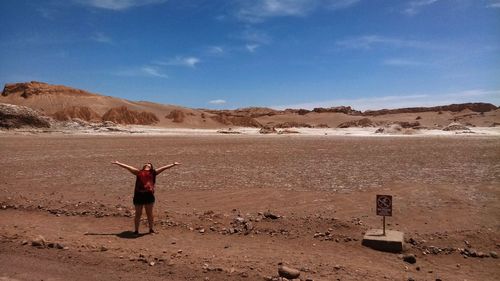 Man standing on desert against sky