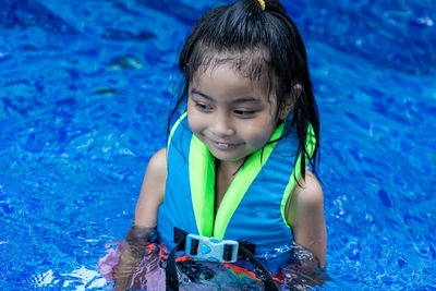 Portrait of happy child in swimming pool