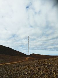 Electricity pylon on landscape against sky