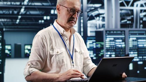 Midsection of man using laptop at office