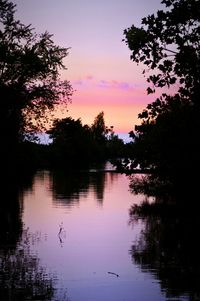 Scenic view of calm lake at sunset